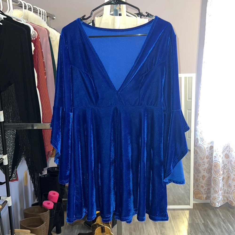 Medium, dark blue, velvet party dress. Low V on the front with ruffled arms